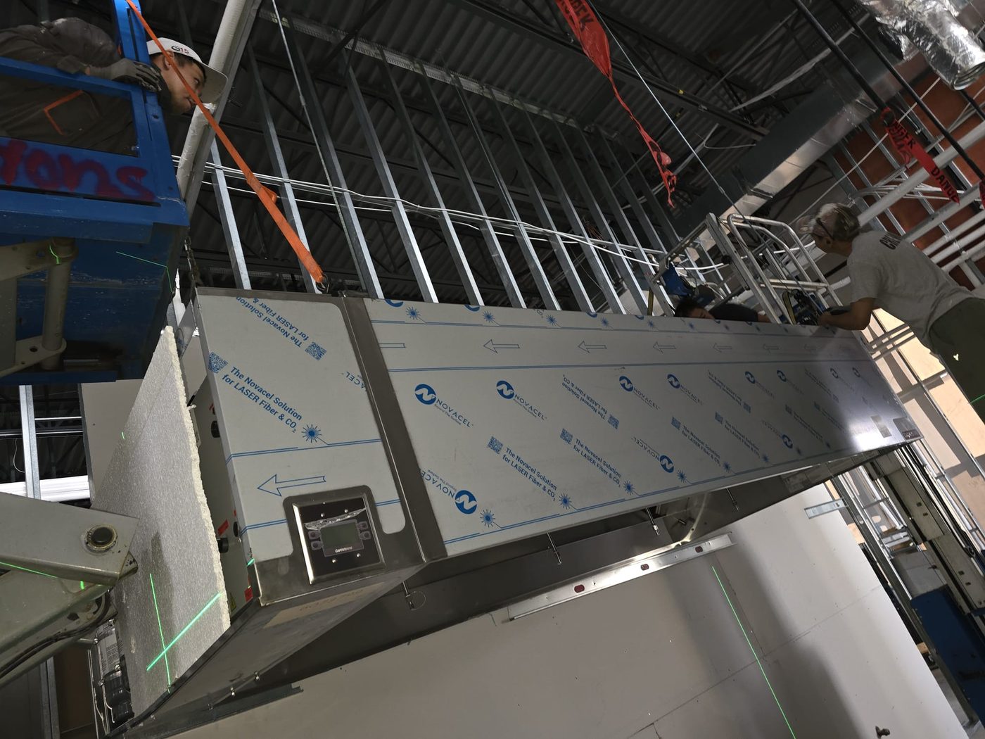 A3 Manpower riggers suspending a custom CaptiveAire extraction hood from the kitchen ceiling.
