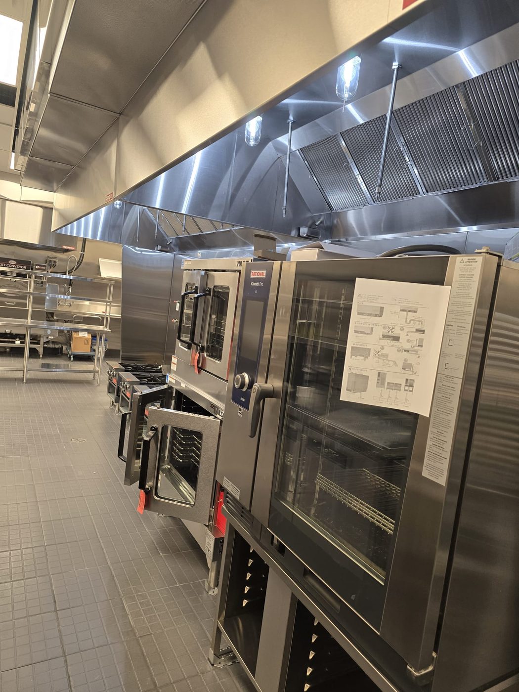 Calibrated Rational combi oven beside the Vulcan heavy-duty hot line.