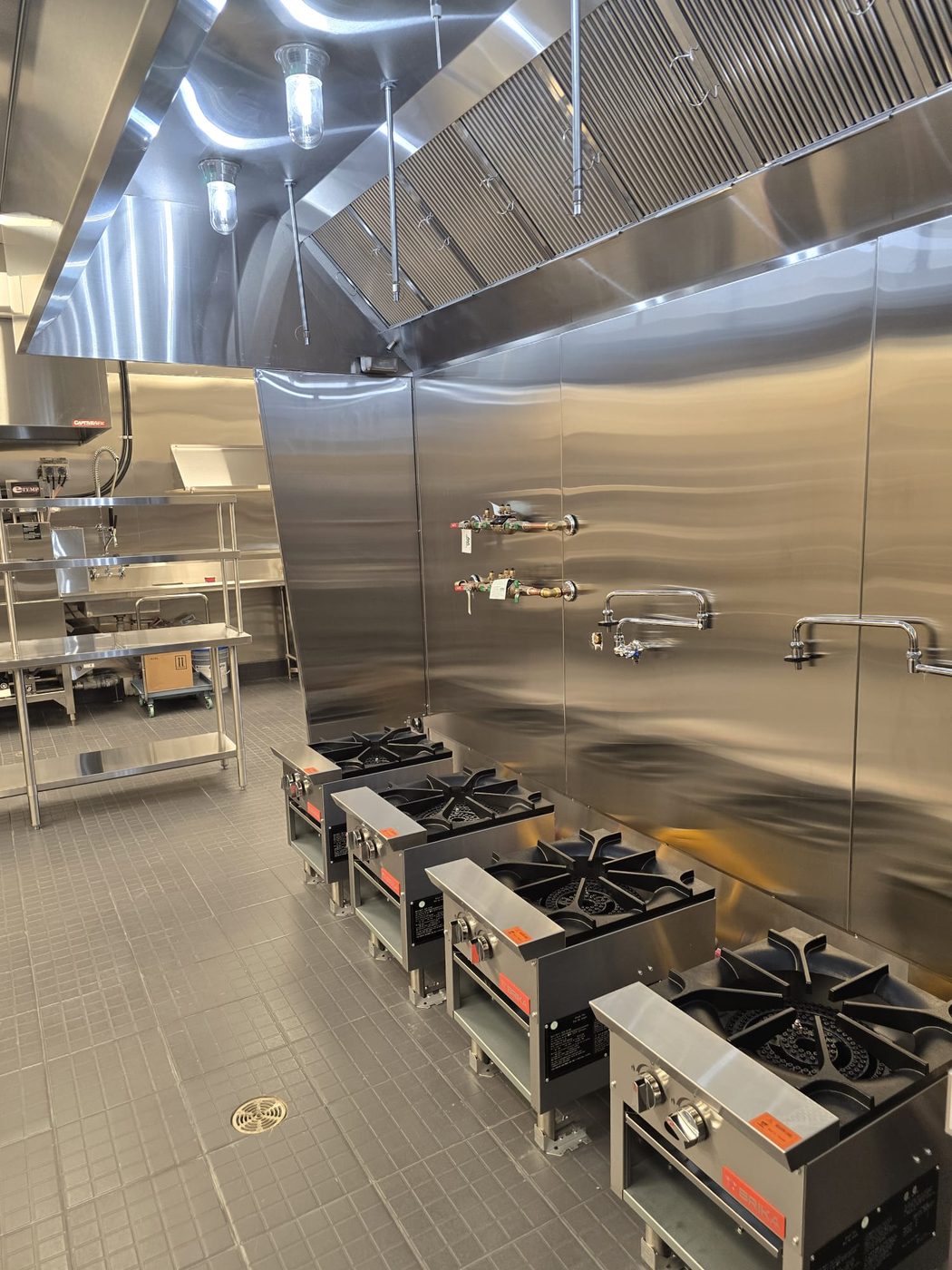 Industrial high-BTU Vulcan stockpot range and specialty range configuration.