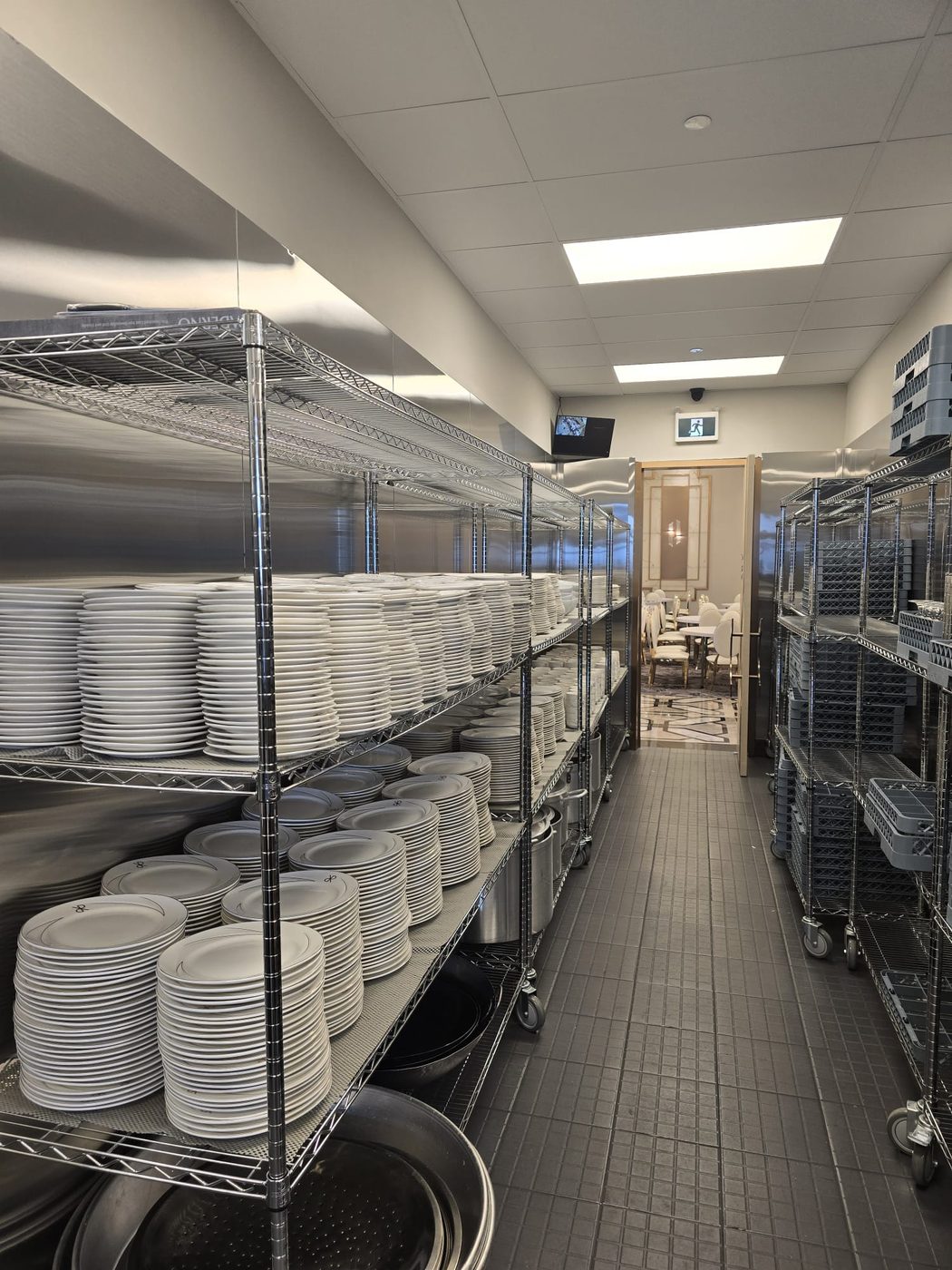 Structural plating racks and mobile transport banks staged for banquet service.