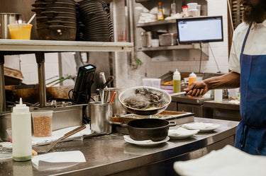 Kitchen staff preparing food on a service line